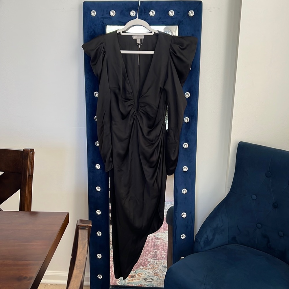 Black Plunge Dress w/exaggerated shoulders.